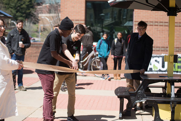 Solar charging station ribbon-cutting draws lunchtime crowd at Appalachian’s Peacock Hall